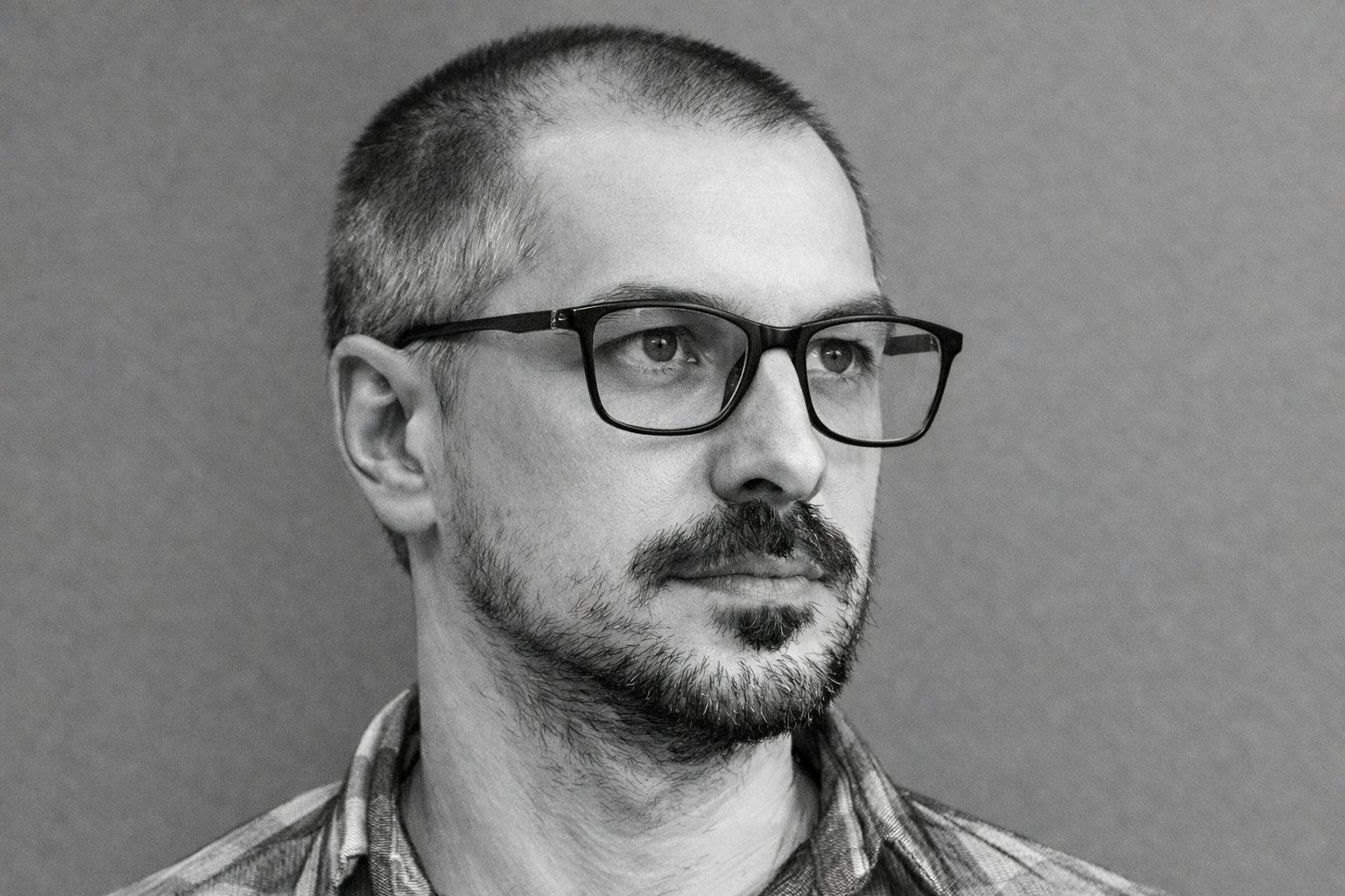 Black-and-white portrait of the founder of Frontwall Studio